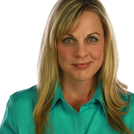 woman smiling light green shirt long hair